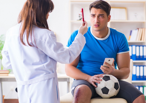 Football player undergoing medical tests with a Doctor